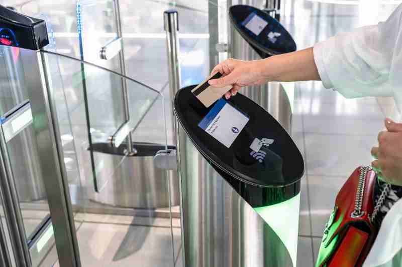Woman using a keycard to open a mantrap door.