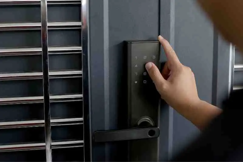Person using a keypad to open their wireless front door locks.