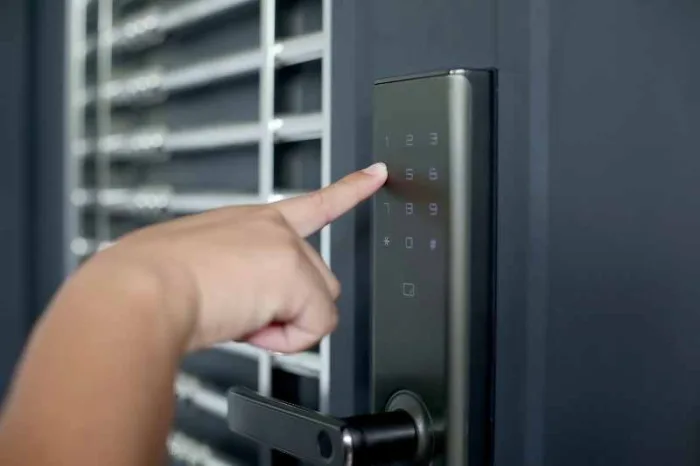 Person using a keypad to open their wireless door locks.