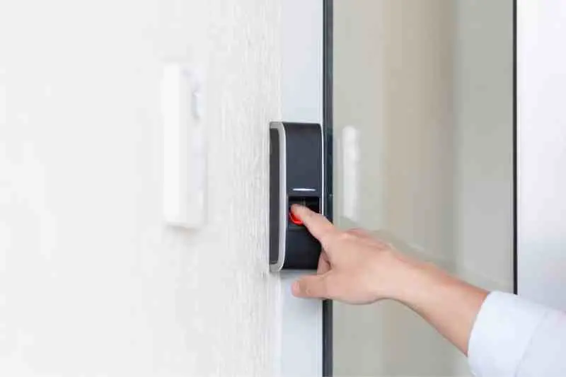 Person using a fingerprint deadbolt lock.
