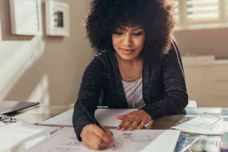 Woman creating a multifamily exit emergency plan.