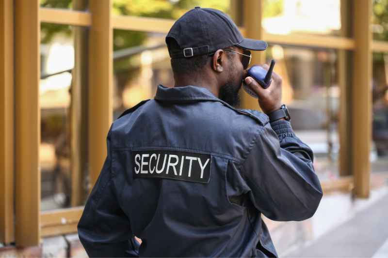 Security guard patrolling a property alongside security companies in Louisville, KY.