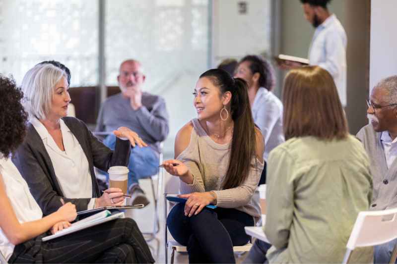 People discussing the responsibilities of HOA board members at a meeting.