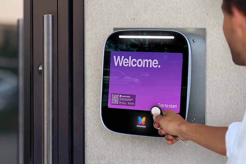 Resident holds a key fob to the ButterflyMX intercom to unlock a door