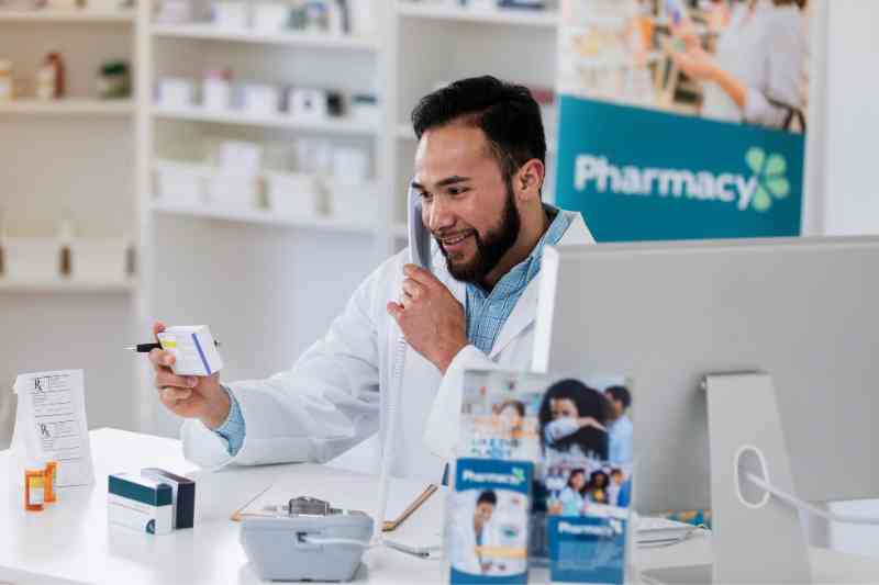 Pharmacist using pharmacy security systems.