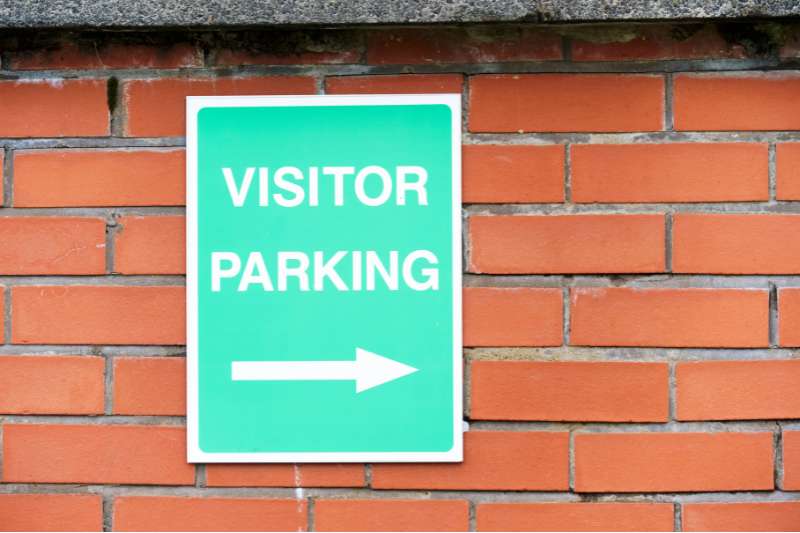 a visitor parking sign is a common visitor parking solution