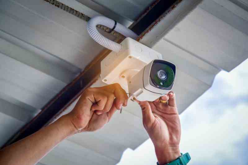 Installer placing commercial security cameras at a business.