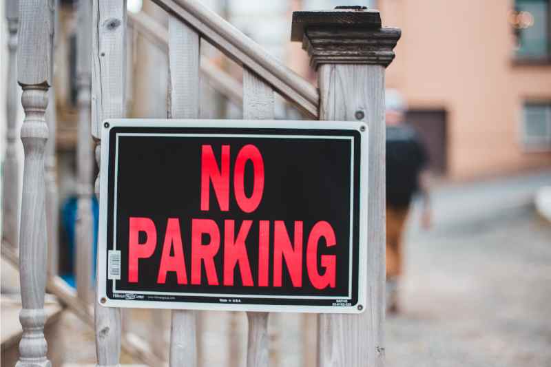 Parking signs as part of a condo visitor parking management system.