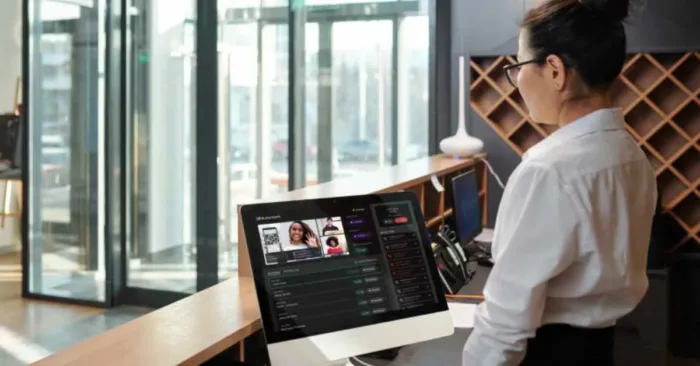 Woman using front desk software.