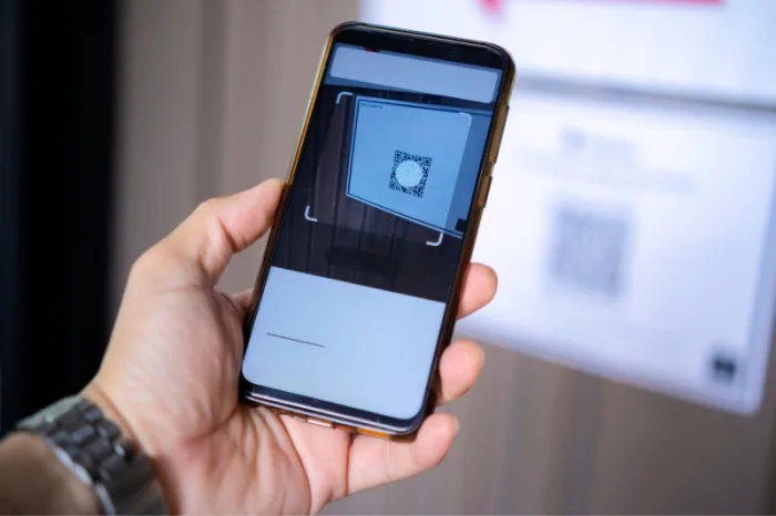 Person scanning qr code visitor management system