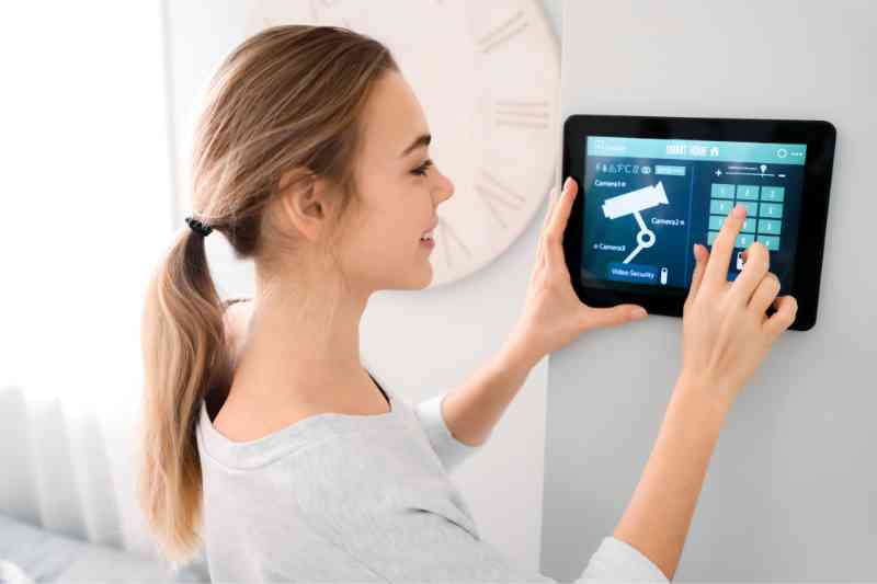 Woman using access control and video surveillance integration technology.