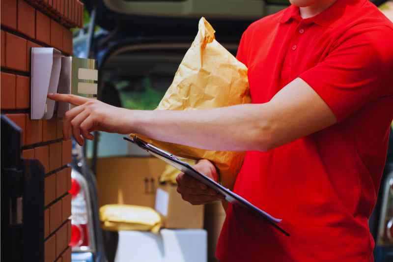 A delivery driver easily using an intercom system. 