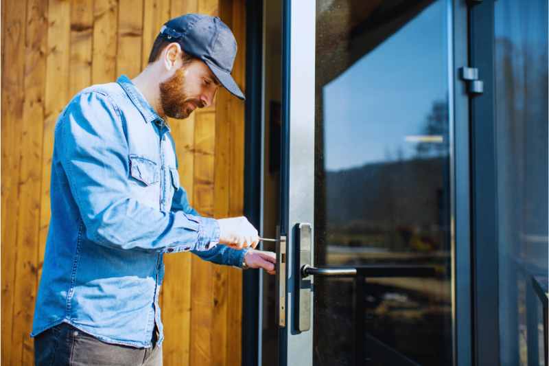 A man installing a rental property lock. 