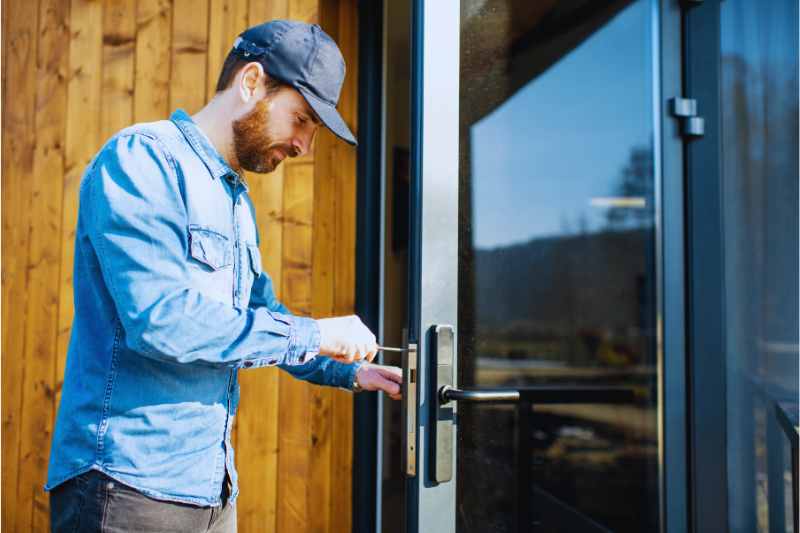 A man installing a rental property lock.