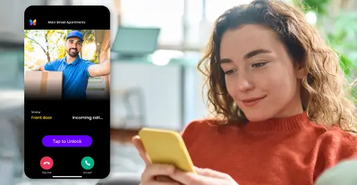 Resident sitting at home smiling at delivery person over video call on ButterflyMX app