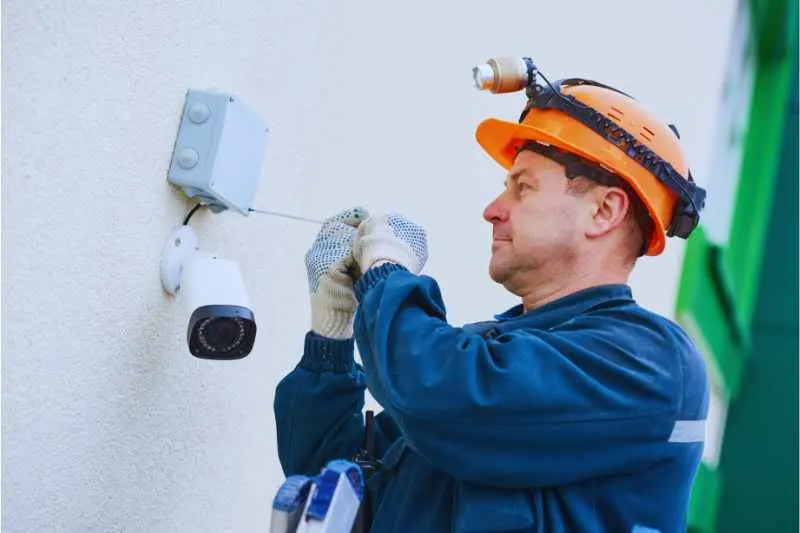 A man installs a cloud-based camera system.