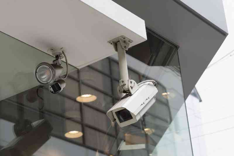 Two multifamily security cameras monitoring entrance.