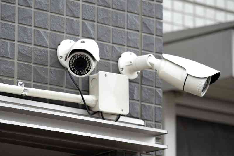 Two multifamily security cameras outside of an apartment building.