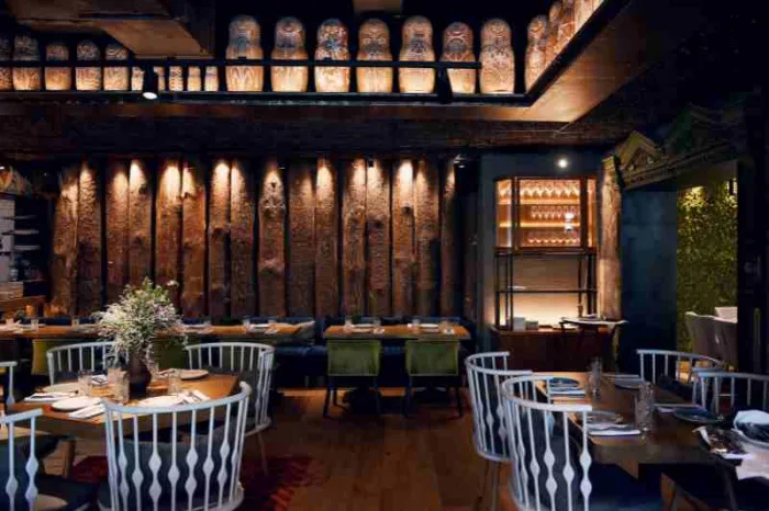 Dimly lit interior restaurant dining room with restaurant security system installed