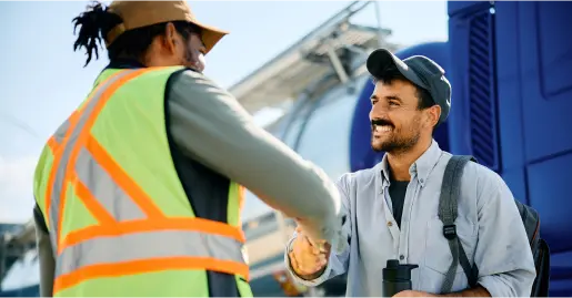 Two industrial workers shaking hands