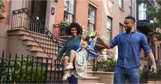 Family walking in a city neighborhood