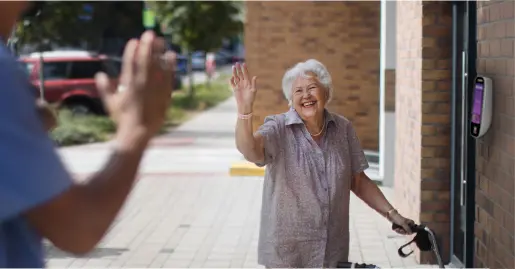 Elderly woman waving