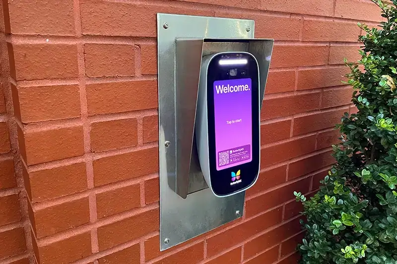 ButterflyMX Video Intercom installed on a brick wall.