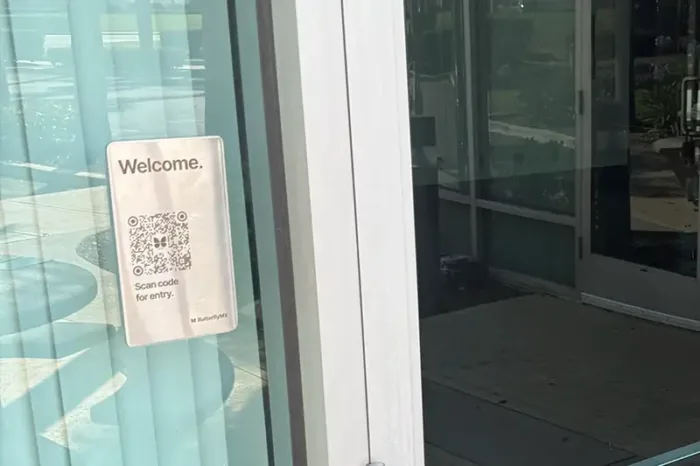 ButterflyMX QR Code Intercom installed on glass wall.