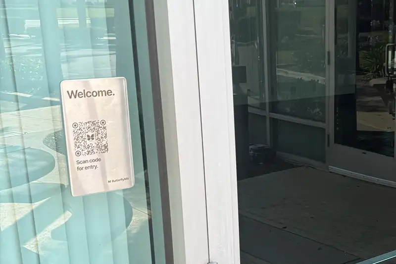 ButterflyMX QR Code Intercom installed on glass wall.
