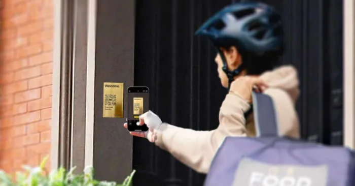 Visitor scanning ButterflyMX QR Code Intercom to contact a resident.