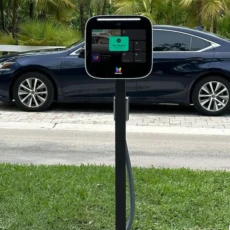 ButterflyMX intercom mounted on pedestal displaying "Gate unlocked" screen at visitor vehicle entrance of gated community ButterflyMX intercom mounted on pedestal displaying "Gate unlocked" screen at visitor vehicle entrance of gated community