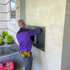 Installer installs a recessed ButterflyMX Video Intercom.
